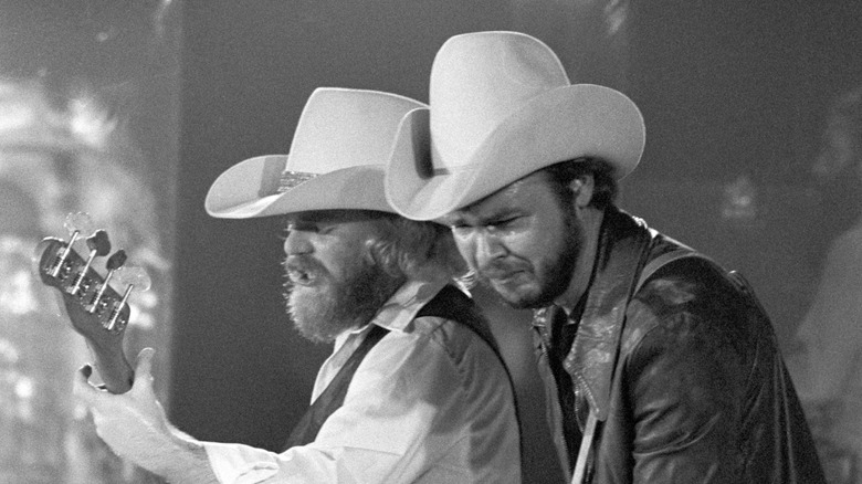 ZZ Top on stage wearing a cowboy hat and holding a guitar